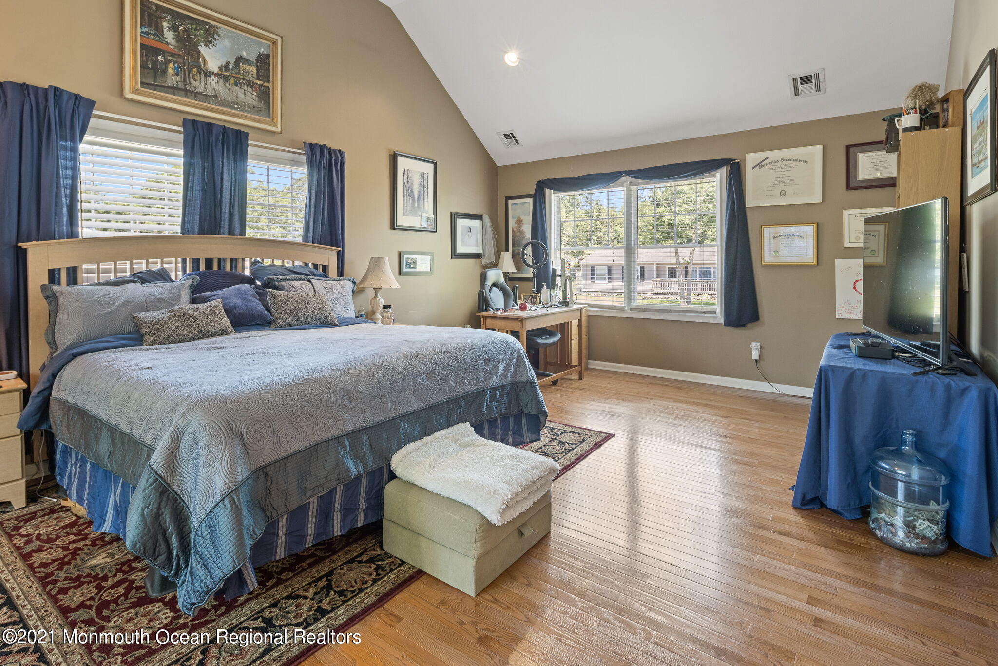 245 Crows Nest Road Manahawkin, NJ 08050 - Photo 29 of 79 a bedroom with a large bed a flat tv screen and a dresser