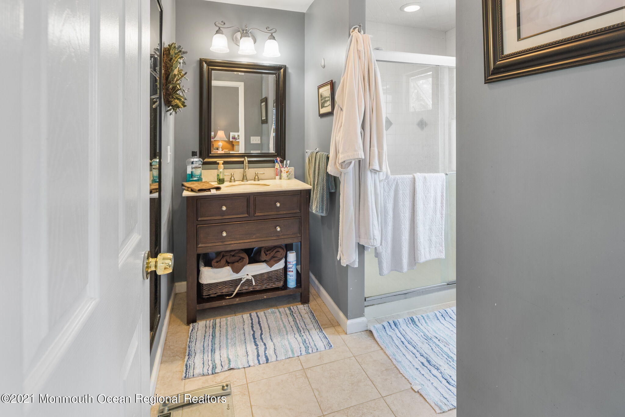 245 Crows Nest Road Manahawkin, NJ 08050 - Photo 33 of 79 a bathroom with a sink a mirror and a shower
