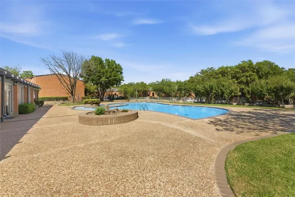 a view of a swimming pool with an outdoor seating and a yard