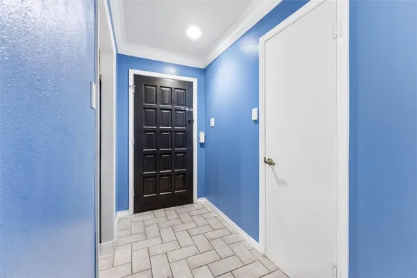 a view of an empty room with window and cabinet