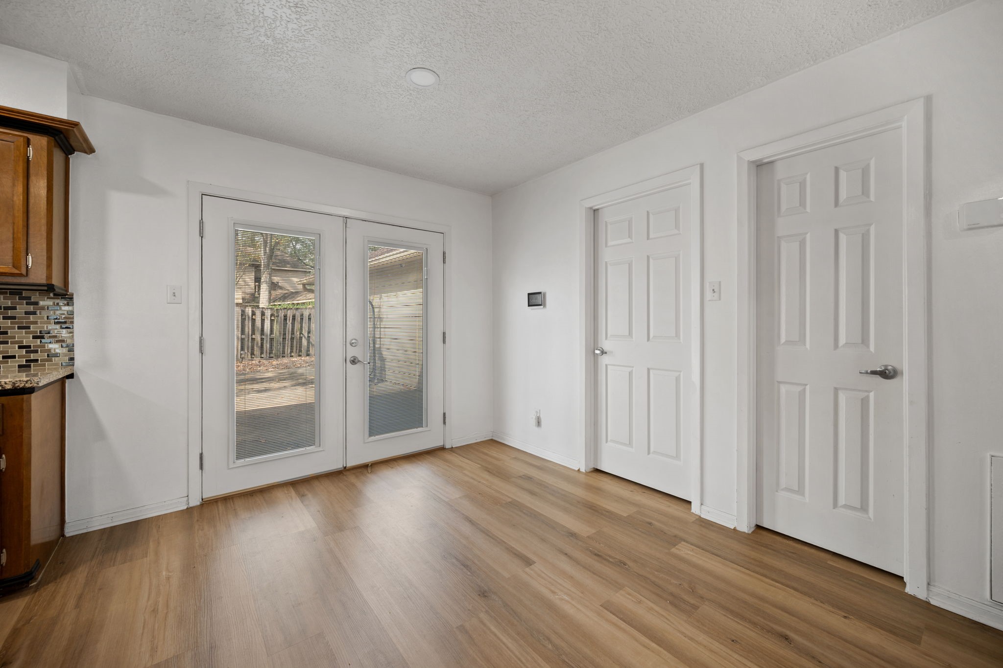 14907 Oak Bluff Court Houston, TX 77070 - Photo 5 of 19 a view of an empty room with wooden floor and a window