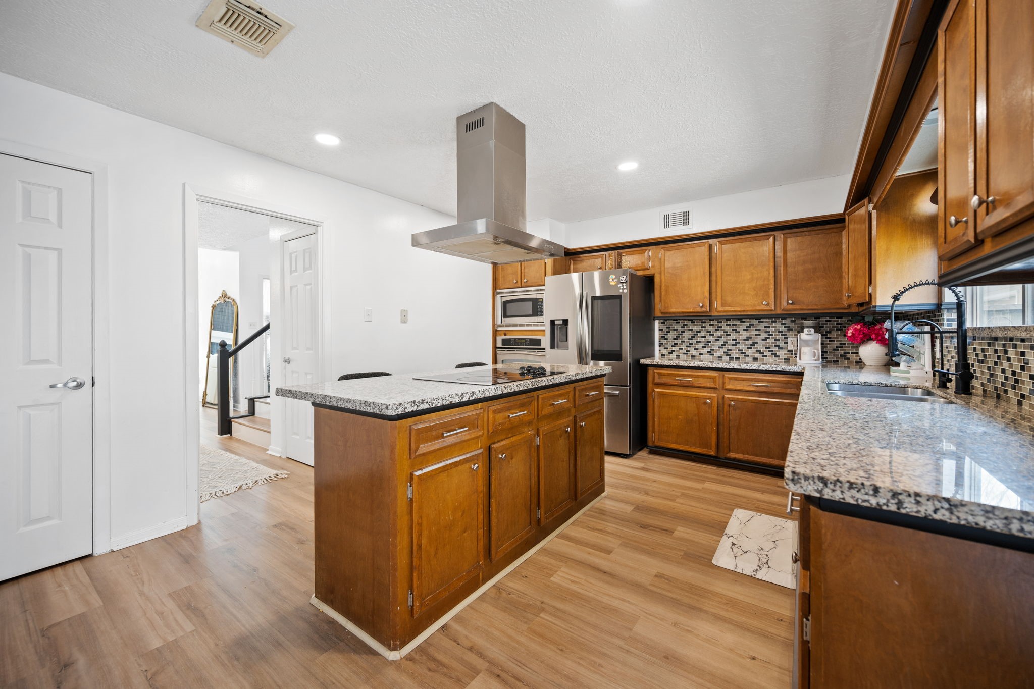 14907 Oak Bluff Court Houston, TX 77070 - Photo 8 of 19 a kitchen with stainless steel appliances granite countertop a stove and a sink