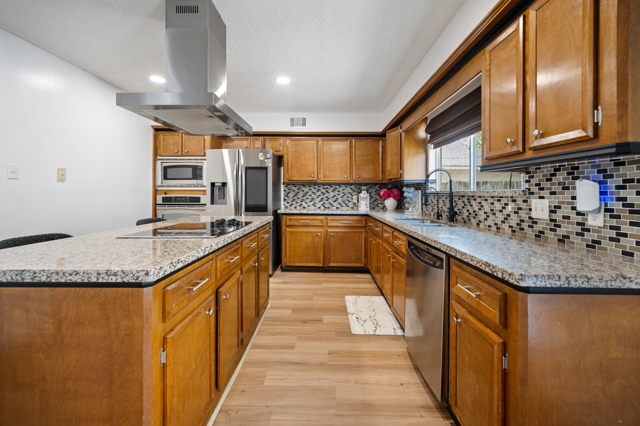14907 Oak Bluff Court Houston, TX 77070 - Photo 9 of 19 a kitchen with stainless steel appliances granite countertop a sink and cabinets