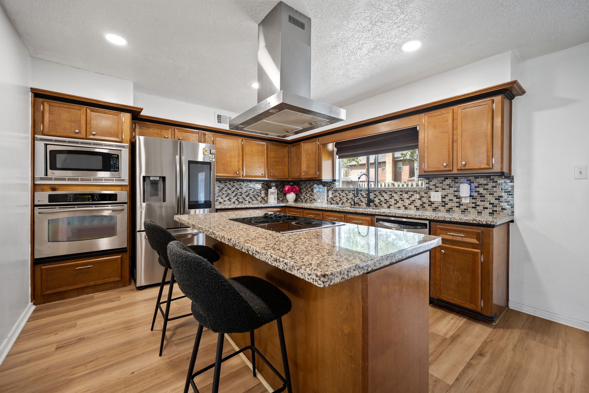 14907 Oak Bluff Court Houston, TX 77070 - Photo 10 of 19 a kitchen with stainless steel appliances granite countertop a sink stove and refrigerator