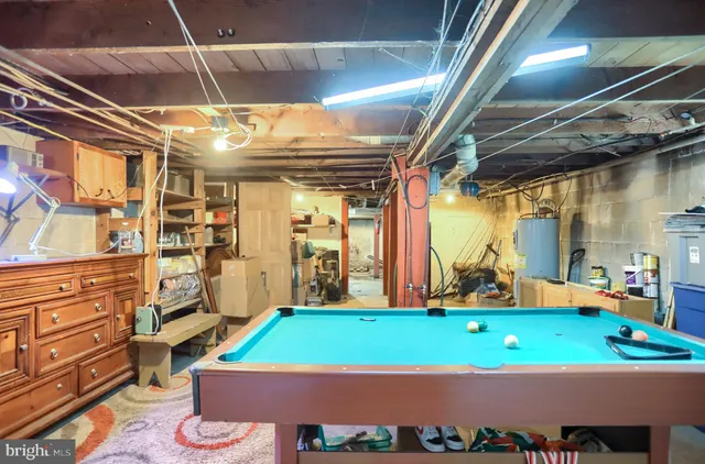 a room with pool table and windows