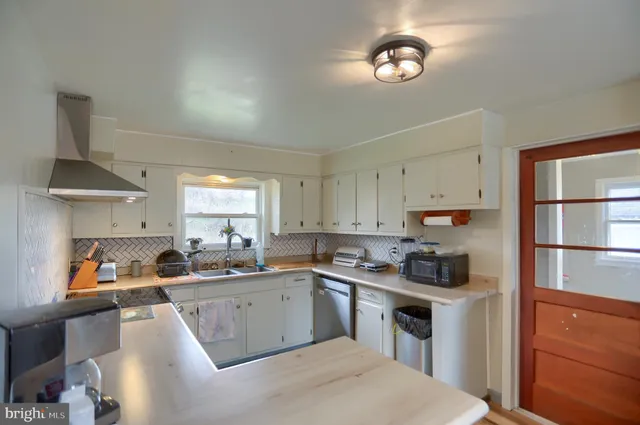 a kitchen with a sink cabinets and window