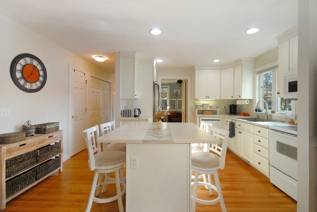 110 Summer Road, Unit 110 Boxborough, MA 01719 - Photo 11 of 28 a large kitchen with a table and chairs