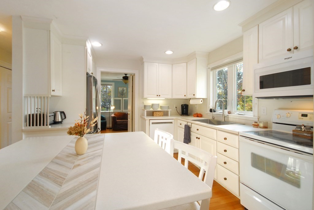 110 Summer Road, Unit 110 Boxborough, MA 01719 - Photo 12 of 28 a large white kitchen with cabinets