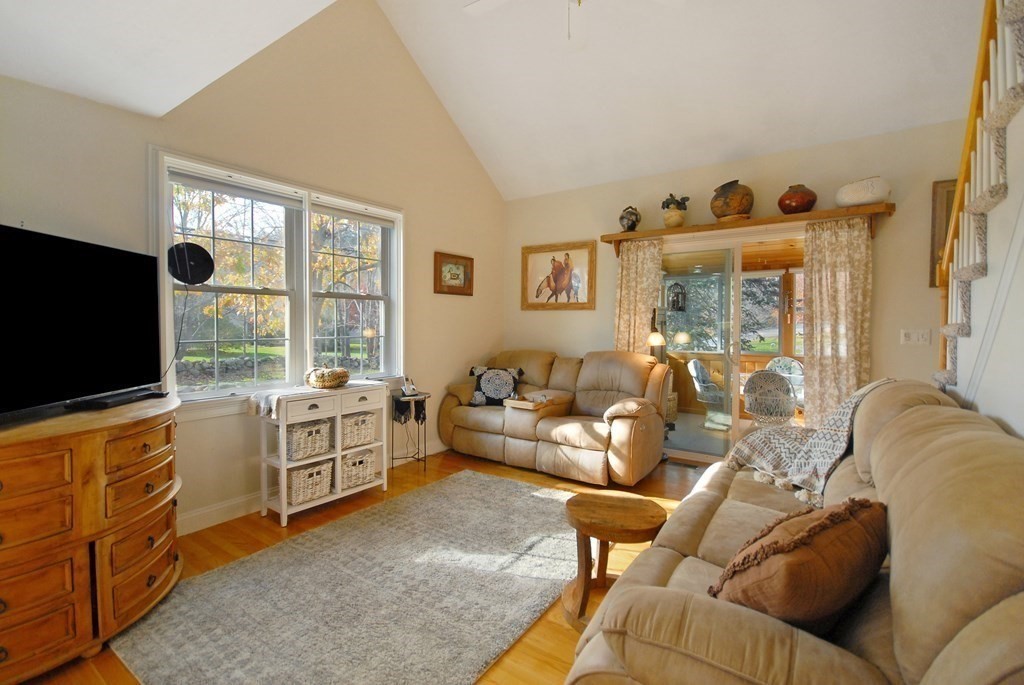 110 Summer Road, Unit 110 Boxborough, MA 01719 - Photo 13 of 28 a living room with furniture and a flat screen tv