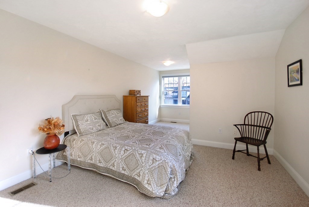 110 Summer Road, Unit 110 Boxborough, MA 01719 - Photo 21 of 28 a bedroom with a bed chair and window