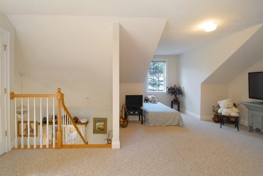 110 Summer Road, Unit 110 Boxborough, MA 01719 - Photo 23 of 28 a living room with furniture and a fireplace