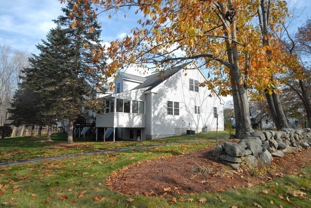 110 Summer Road, Unit 110 Boxborough, MA 01719 - Photo 28 of 28 a front view of a house with a yard