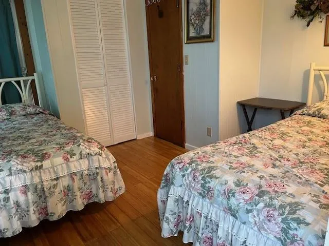 a bed sitting in a spacious bedroom next to a window