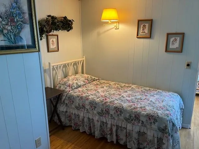 a bathroom with a shower curtain and a toilet next to a window