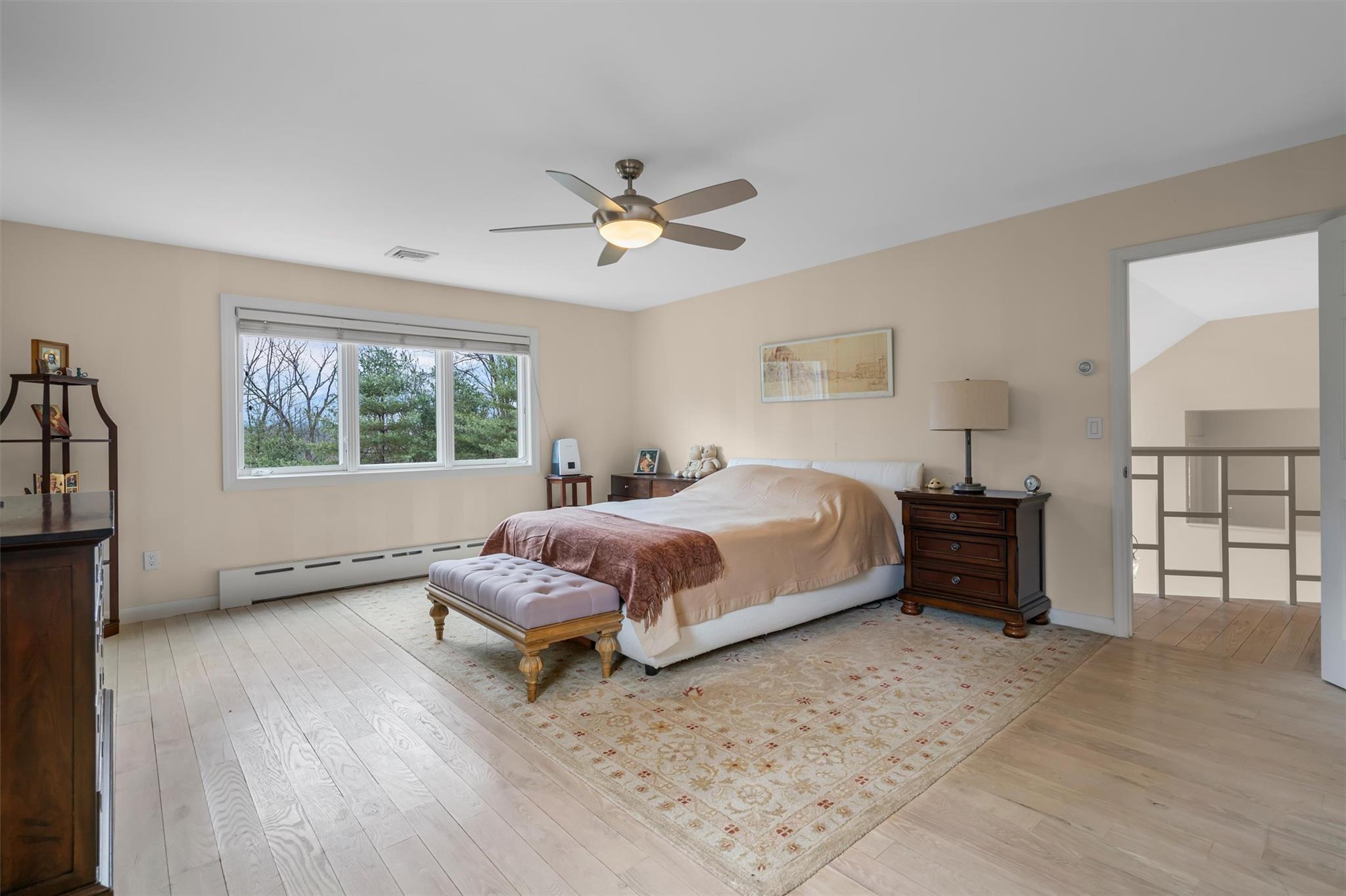 36 Chardavoyne Road Warwick, NY 10990 - Photo 19 of 46 Bedroom with light wood finished floors, visible vents, a baseboard heating unit, and baseboards