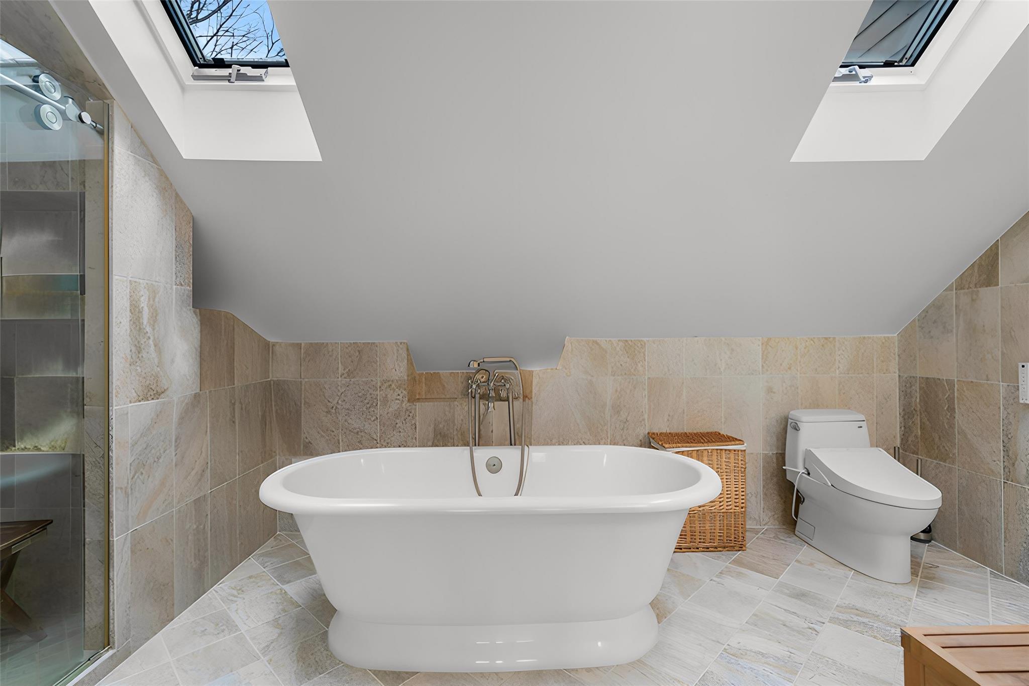 36 Chardavoyne Road Warwick, NY 10990 - Photo 21 of 46 Full bathroom featuring lofted ceiling with skylight, toilet, tile walls, a soaking tub, and walk in shower