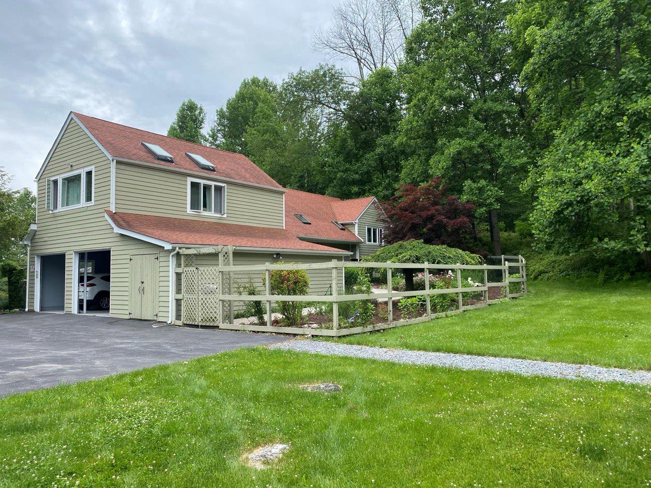 36 Chardavoyne Road Warwick, NY 10990 - Photo 32 of 46 View of front facade featuring a garage, driveway, a front lawn, and a shingled roof
