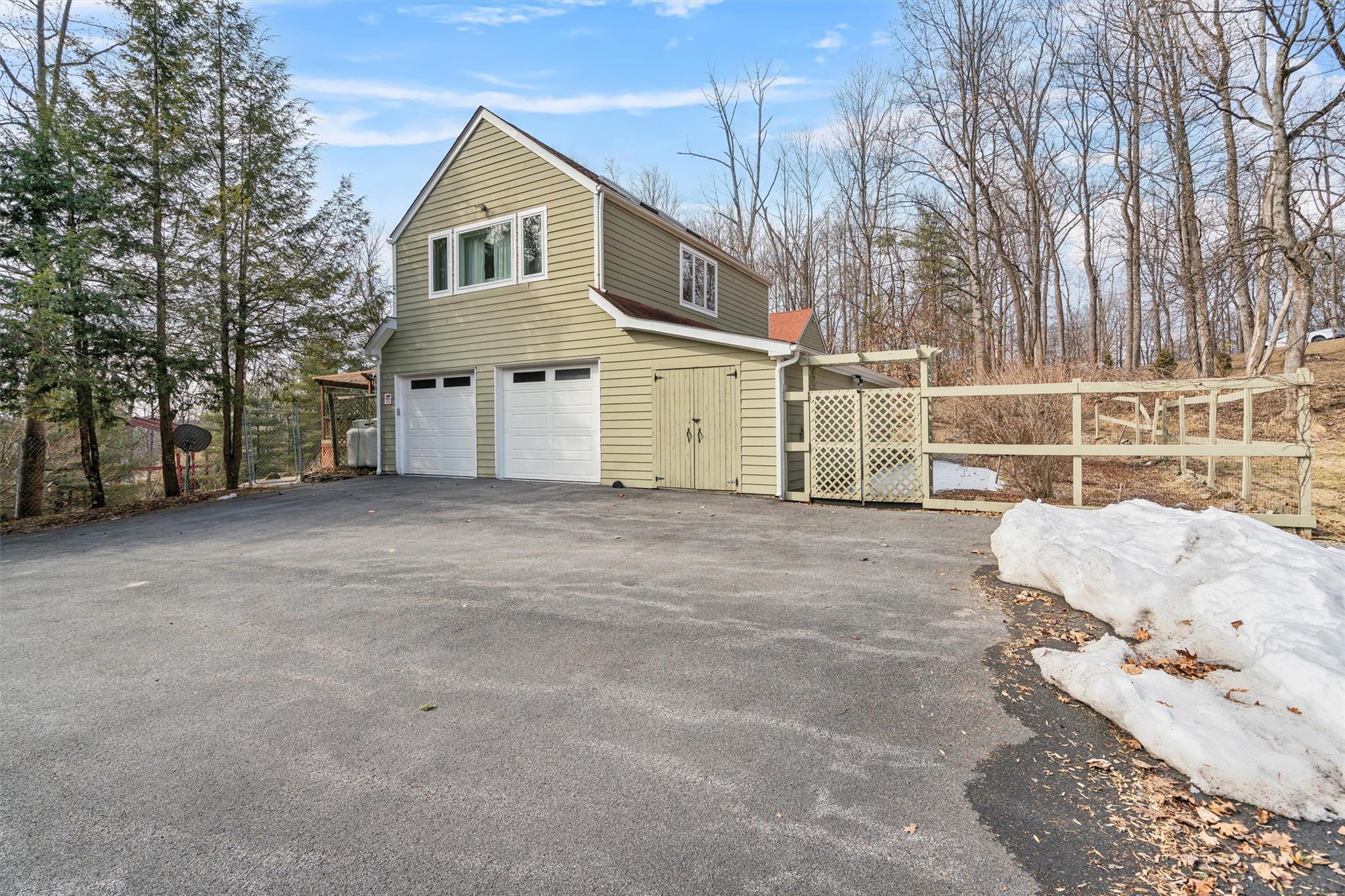 36 Chardavoyne Road Warwick, NY 10990 - Photo 40 of 46 View of side of property featuring aphalt driveway, a garage, and fence