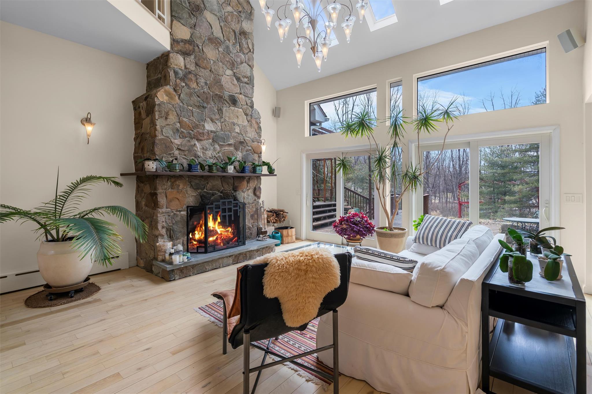 36 Chardavoyne Road Warwick, NY 10990 - Photo 5 of 46 Living area featuring high vaulted ceiling, a stone fireplace, and wood finished floors