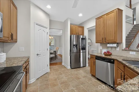 a kitchen with a refrigerator sink and cabinets