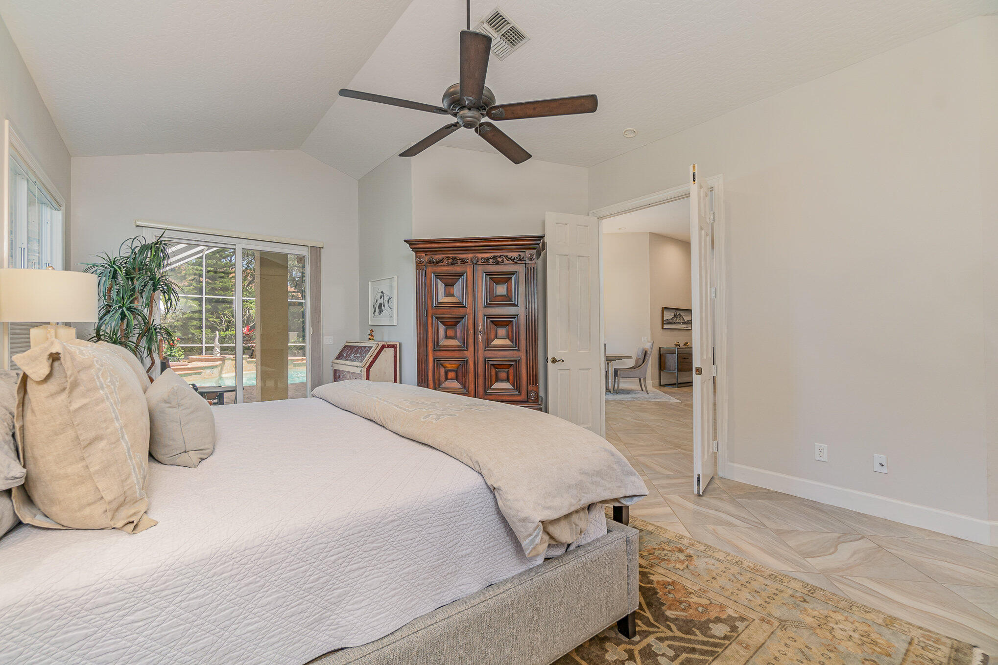 789 Oak Park Drive Melbourne, FL 32940 - Photo 11 of 44 a bedroom with a large bed and a chandelier