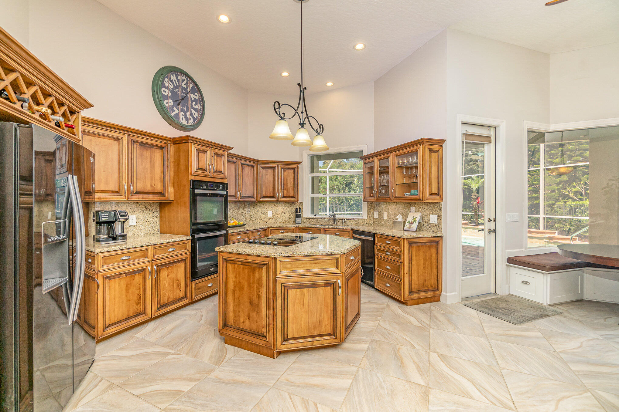 789 Oak Park Drive Melbourne, FL 32940 - Photo 16 of 44 a kitchen with a stove kitchen island wooden cabinets and stainless steel appliances