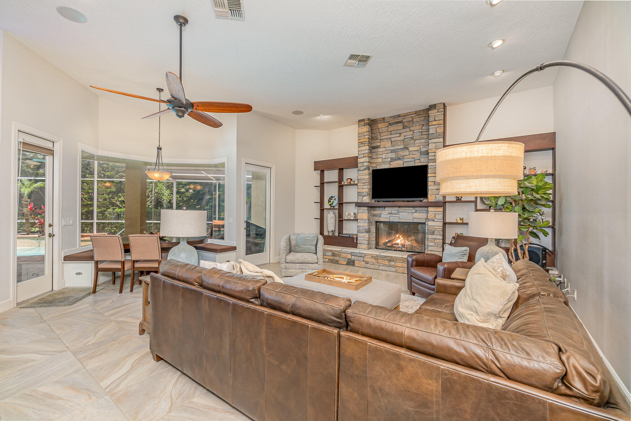 789 Oak Park Drive Melbourne, FL 32940 - Photo 21 of 44 a living room with furniture a flat screen tv and a large window