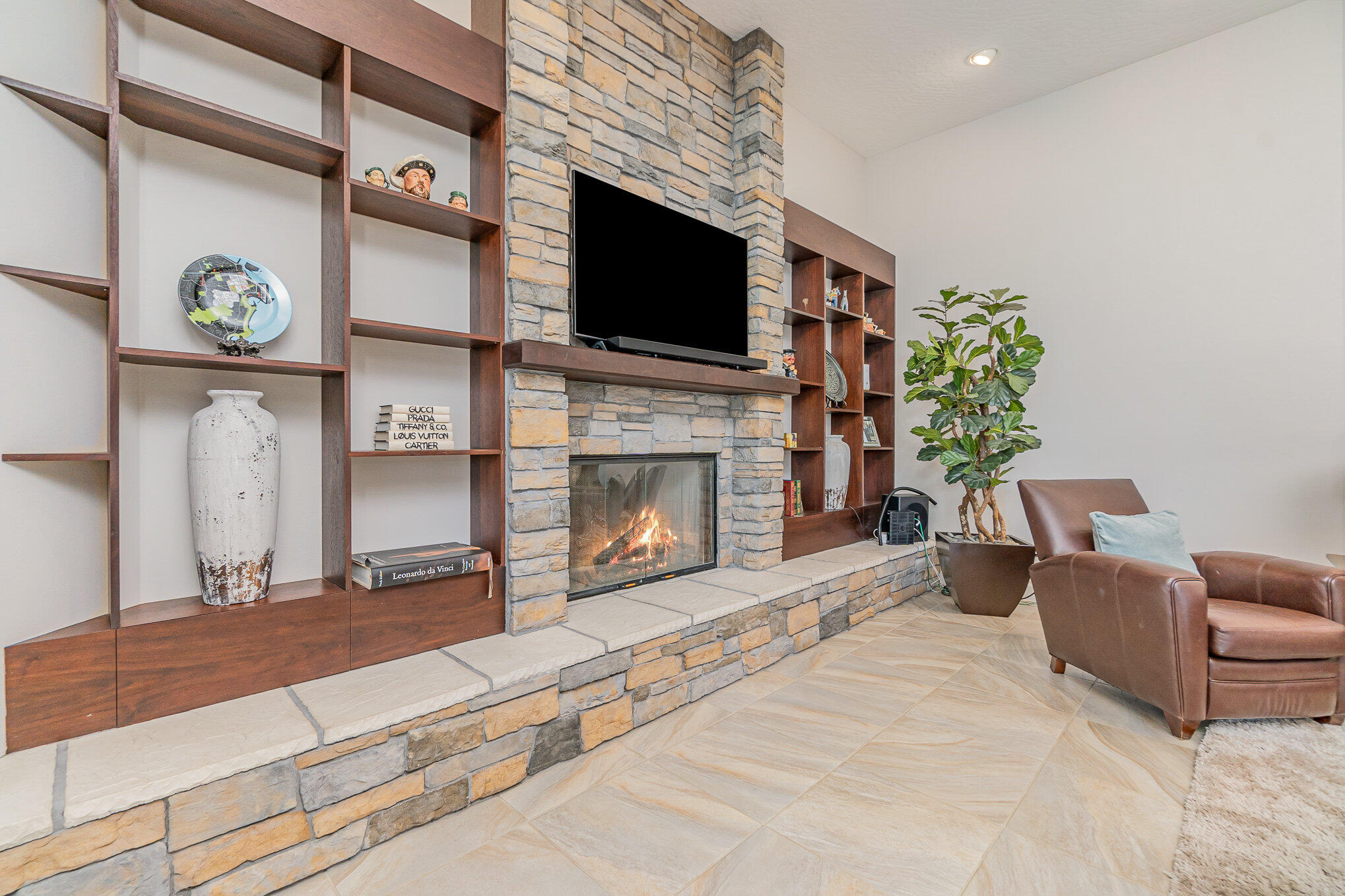 789 Oak Park Drive Melbourne, FL 32940 - Photo 23 of 44 a living room with furniture a flat screen tv and a fireplace