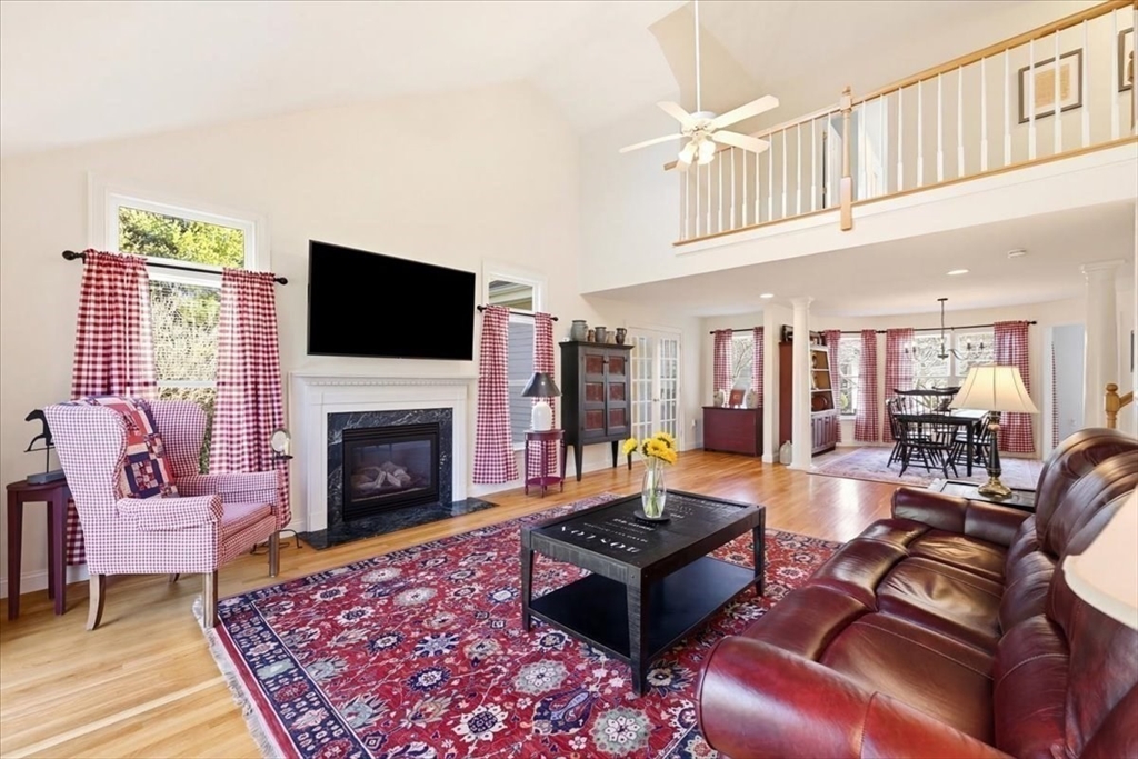 8 Country Circle, Unit 8 Norton, MA 02766 - Photo 11 of 42 a living room with furniture a flat screen tv and a fireplace