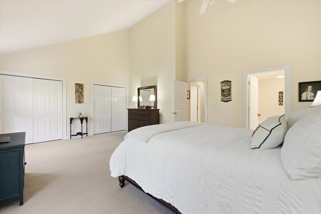 8 Country Circle, Unit 8 Norton, MA 02766 - Photo 20 of 42 a bedroom with a bed and a large mirror