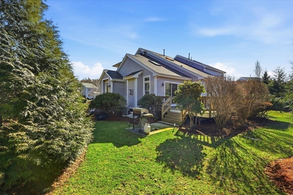 8 Country Circle, Unit 8 Norton, MA 02766 - Photo 2 of 42 a house with garden in front of it