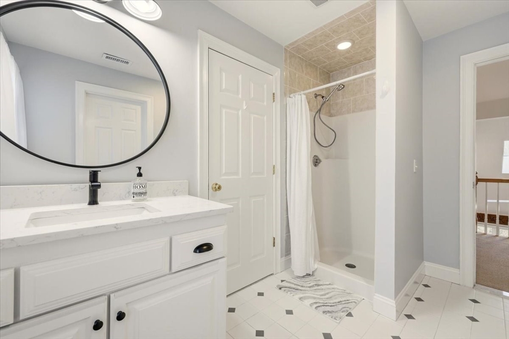 8 Country Circle, Unit 8 Norton, MA 02766 - Photo 28 of 42 a bathroom with a sink a mirror a vanity and shower