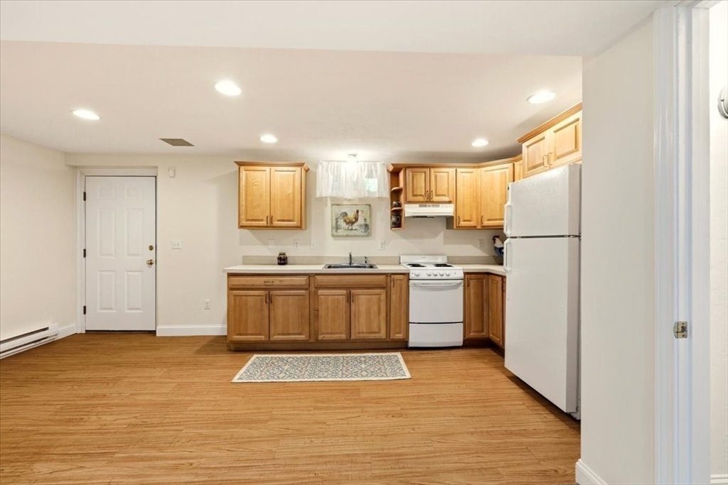 8 Country Circle, Unit 8 Norton, MA 02766 - Photo 29 of 42 a kitchen with a refrigerator a sink and a stove top oven