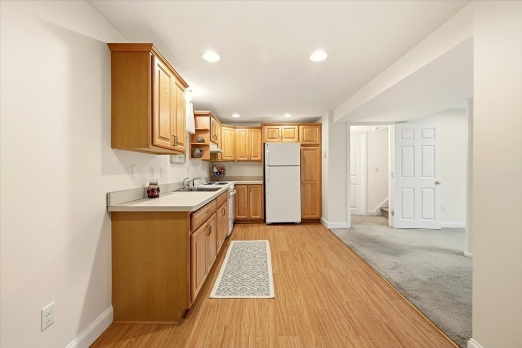 8 Country Circle, Unit 8 Norton, MA 02766 - Photo 30 of 42 a kitchen with a sink a counter top space and stainless steel appliances