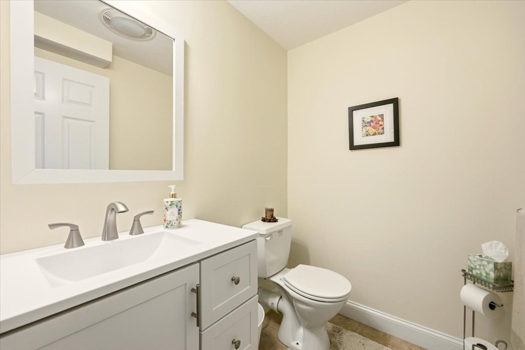8 Country Circle, Unit 8 Norton, MA 02766 - Photo 33 of 42 a bathroom with a sink mirror vanity and toilet