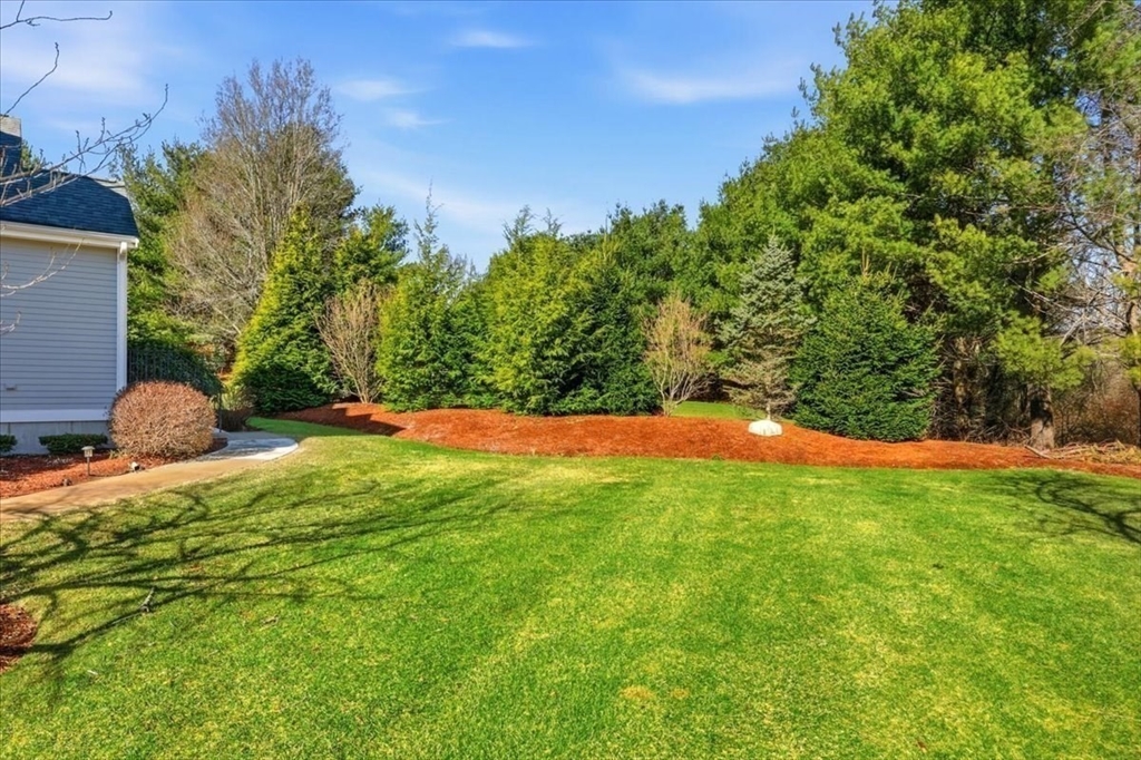 8 Country Circle, Unit 8 Norton, MA 02766 - Photo 36 of 42 a backyard of a house with lots of green space
