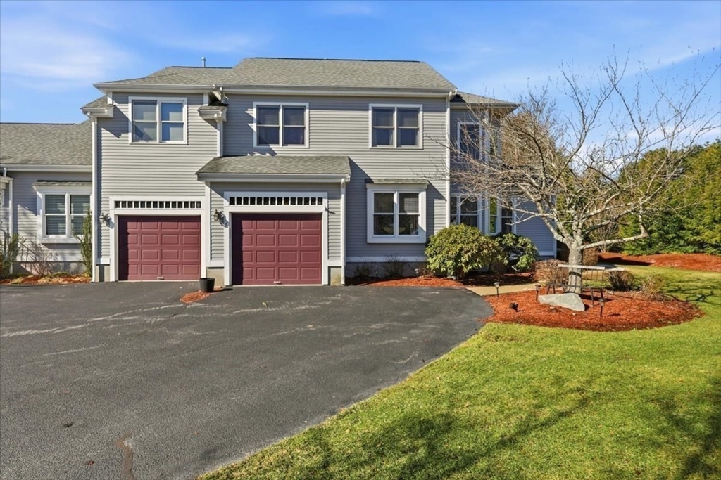 8 Country Circle, Unit 8 Norton, MA 02766 - Photo 38 of 42 a front view of a house with a yard and garage