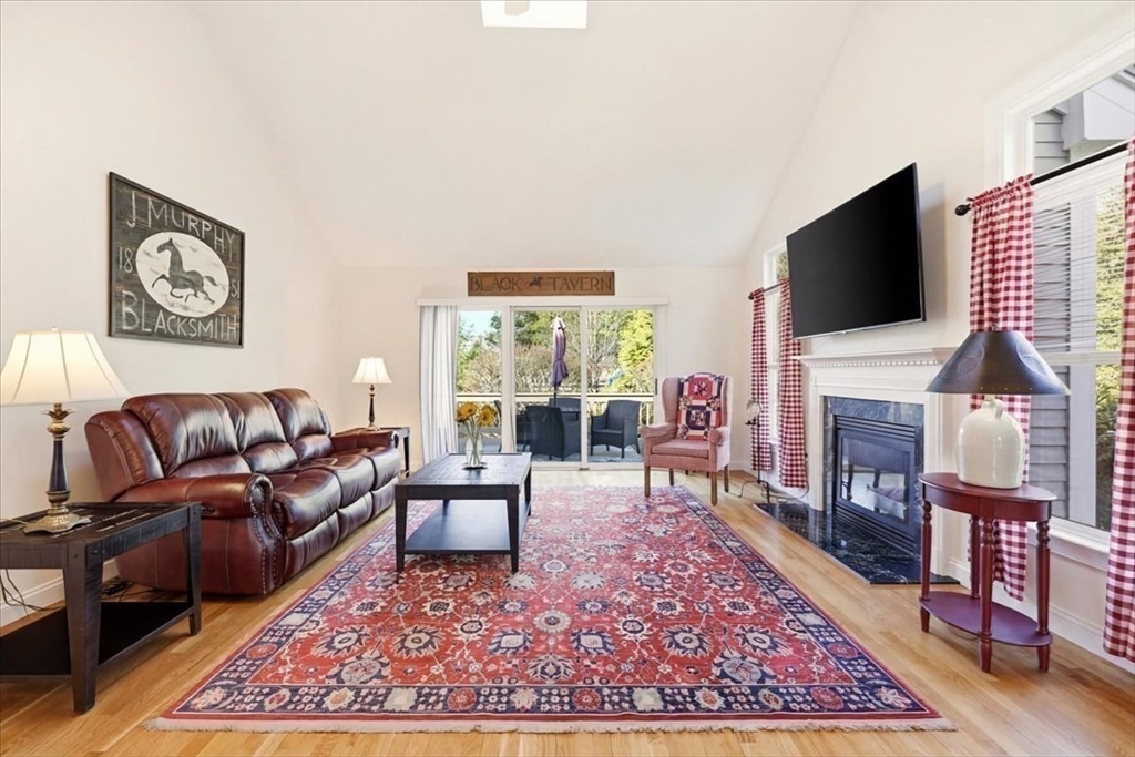 8 Country Circle, Unit 8 Norton, MA 02766 - Photo 8 of 42 a living room with fireplace furniture and a flat screen tv