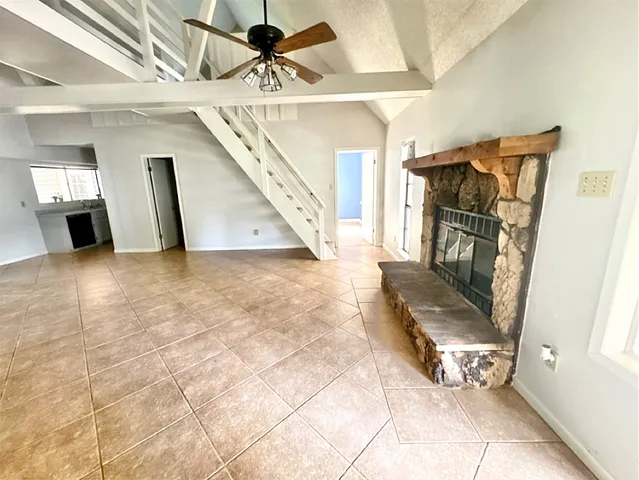 a view of a livingroom with furniture and a hallway