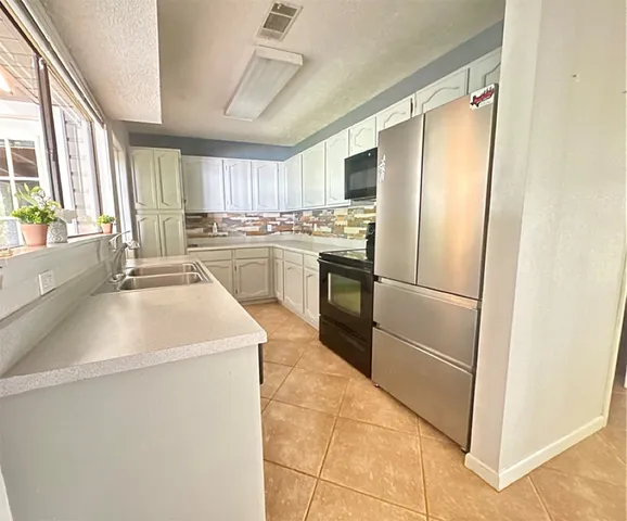 a kitchen with appliances cabinets and furniture