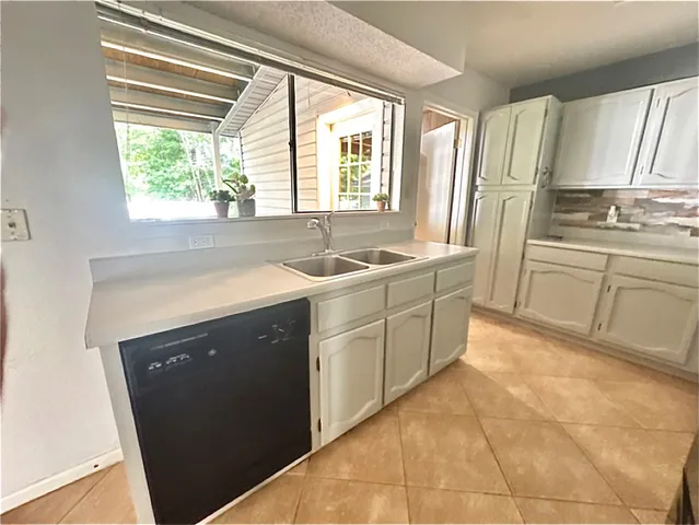 a kitchen with stainless steel appliances a sink stove and cabinets