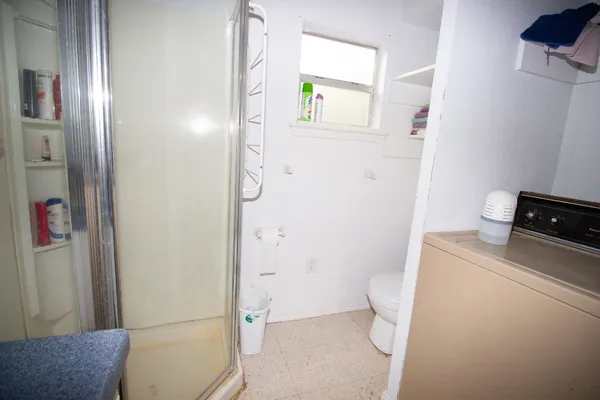 a bathroom with a toilet and a shower