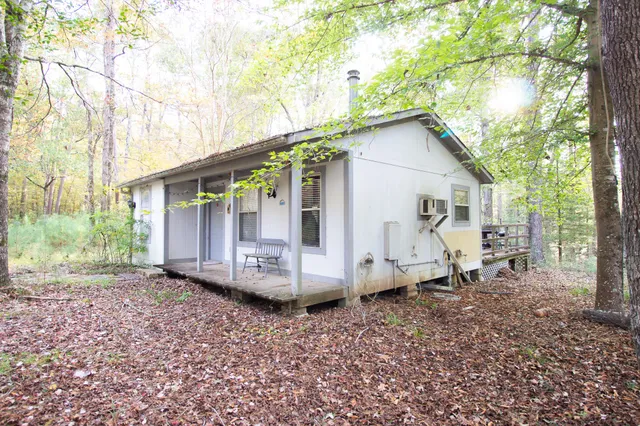 a view of a small house with a yard