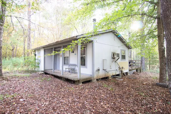 a view of a small house with a yard