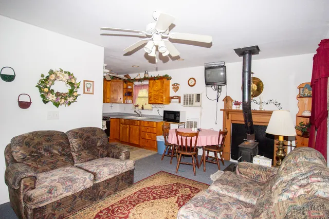 a living room with furniture a chandelier and a flat screen tv