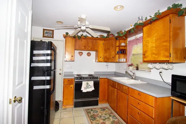 a kitchen with stainless steel appliances granite countertop a sink and cabinets