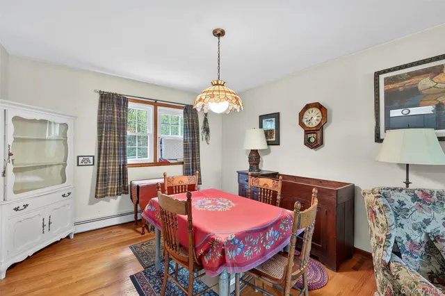 a dining room with furniture and window