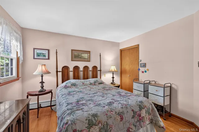 a bathroom with a granite countertop toilet sink and mirror