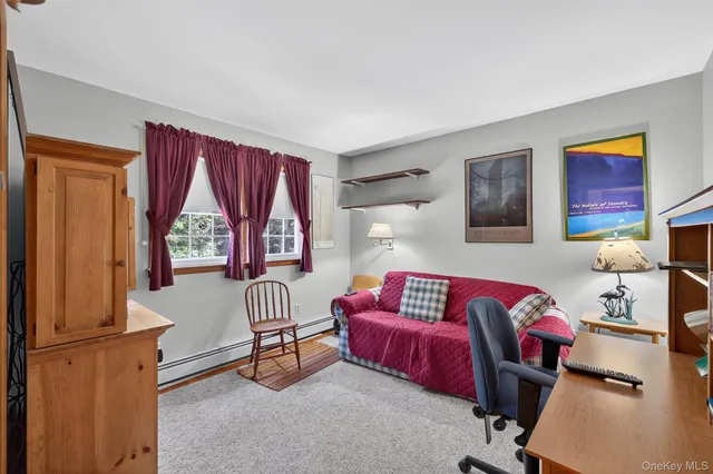 a view of staircase with lots of frames on wall and a window