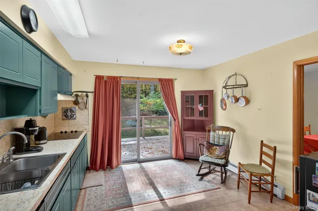 a view of kitchen with stainless steel appliances granite countertop a refrigerator and a stove top oven